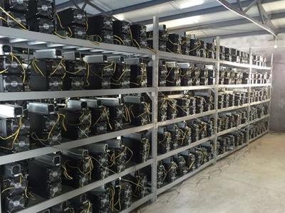 Massive cryptocurrency mining farm with rows of mining rigs